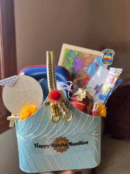 A side view of the elegant blue Raksha Bandhan basket, showing how all the items are carefully arranged to be visible.