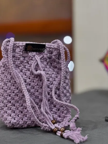 A simple and sweet lavender potli bag. The drawstring closure is finished with wooden beads.