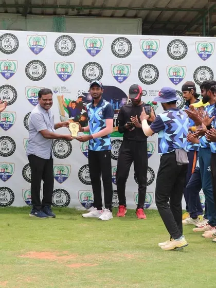 The captain of a team accepts a trophy on behalf of his players, celebrating their collective effort.