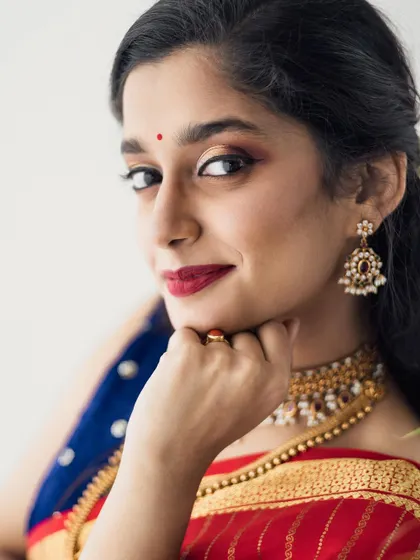 A close-up showing the winged eyeliner and red lip combination. This is a versatile look that works for both photoshoots and special events.