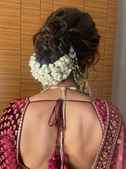 The texture in this messy bun adds a modern touch to the traditional gajra hairstyle, making it feel soft and romantic.