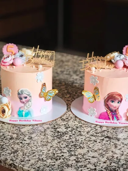 Here are the finished twin Frozen cakes, one for Elsa and one for Anna. It's a great way to give each twin her own special cake while keeping the theme consistent.