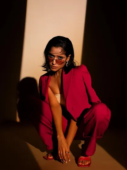 Power dressing with a twist. This look from a studio lookbook demonstrates my skill in styling contemporary formal wear, using dramatic lighting and strong poses to highlight the suit's sharp tailoring and bold color.