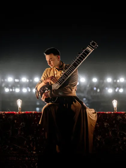 A quiet moment on a grand stage. Even in a massive arena, I create pockets of intimacy, drawing the audience in with the delicate sounds of the sitar.