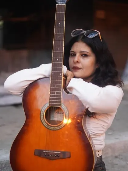 A close-up portrait with the guitar. My styling is about capturing a vibe, not just putting clothes together.