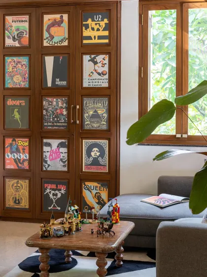 A close-up of the hidden bar, concealed behind wooden panels adorned with our favorite posters.