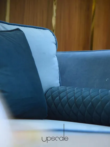 A close-up on the sofa's armrest, showcasing the quilted detail that adds another layer of texture and craftsmanship to the piece.