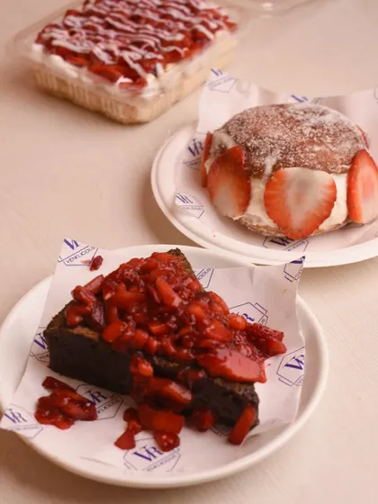 A beautiful spread from our strawberry menu, featuring the gooey brownie with strawberries, a strawberry Berliner, and our strawberry tres leches.