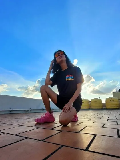 Capturing the mood. This shot against the sky shows off the casual, confident attitude that comes with a great oversized tee and a pair of cool shades.