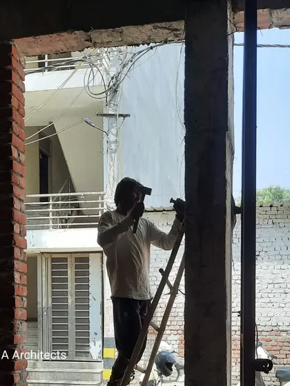 A worker on-site, focused on the structural details of a column. This hands-on work is essential to ensuring every component of the building meets our rigorous standards for quality and durability.