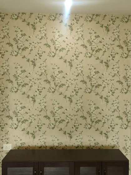 This small accent wall behind a console table is brought to life with a delicate white and green floral wallpaper. It shows how even a small amount of wallpaper can make a big impact in a room.