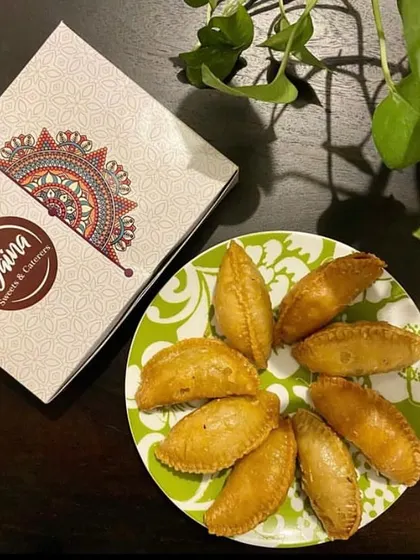 Our delicious, crispy Gujiyas served fresh and ready to be enjoyed. They come packed in our signature boxes, making them a great Holi gift.