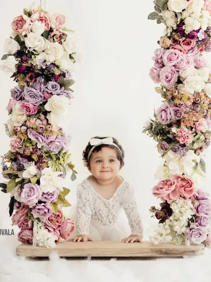 A beautiful portrait of a little girl on our floral swing. The soft, dreamy clouds at her feet add a touch of magic to the photo.