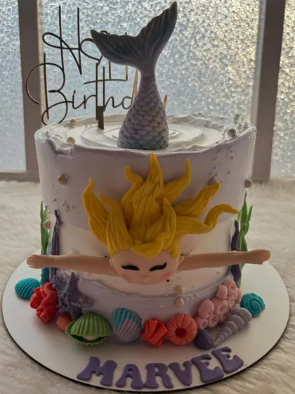 A magical mermaid cake with a swimming mermaid and an underwater scene.
