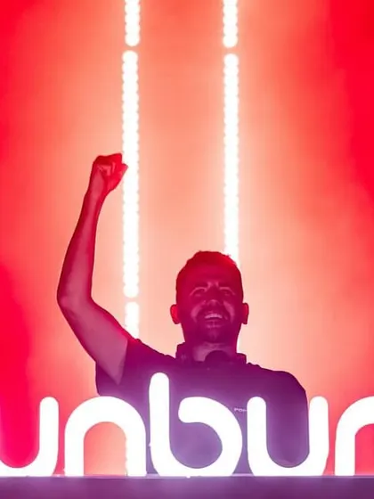 Dimitri Vegas celebrating behind the iconic Sunburn logo after a killer set.