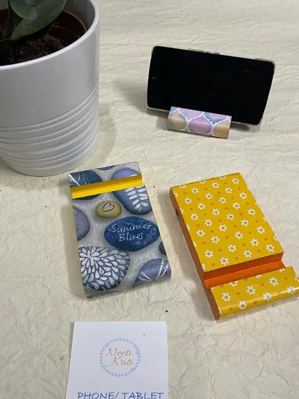 These phone stands feature a pebble print and a yellow floral print.