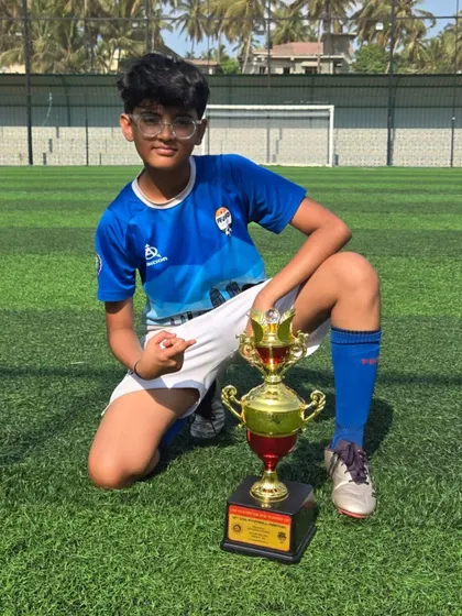 A confident pose from a U14 champion with his trophy.