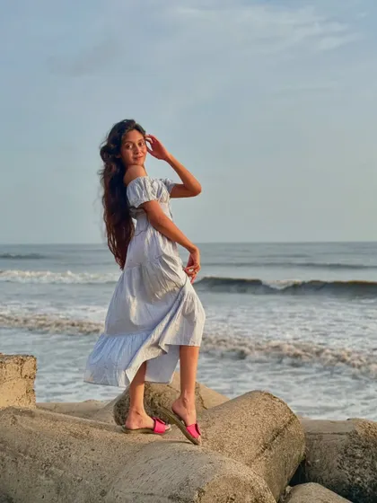 A smiling pose in a pretty dress against the ocean backdrop. Capturing these happy memories is a huge part of the fun.
