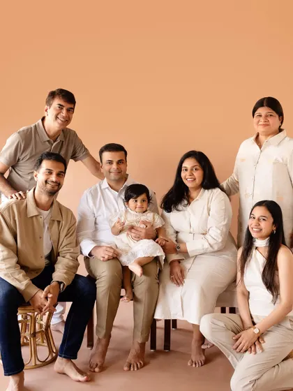A full extended family portrait against a warm, neutral backdrop in the studio. We love capturing multiple generations in one frame.