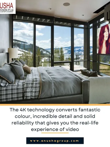 This bedroom showcases a unique integration of entertainment and comfort. A 4K projector screen descends from the ceiling, while automated blackout shades close to create an immersive home theatre experience, all against a backdrop of stunning window views.