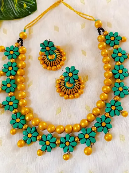 These are additional images of the floral necklace sets in various colors, showcasing the wide range of options available for bulk purchase.