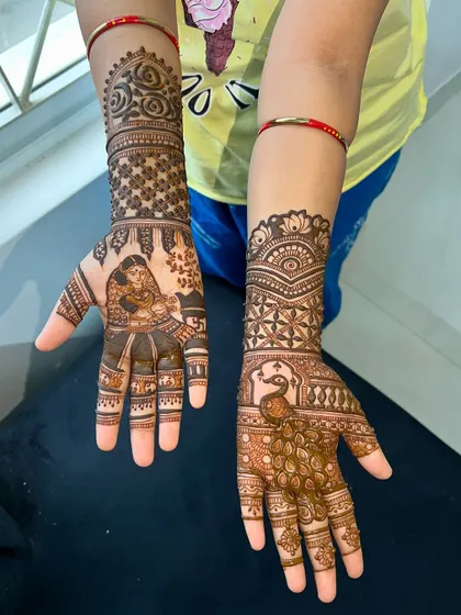 A view of both hands together, showing the complete story of Savitri and Satyavan for the festival.