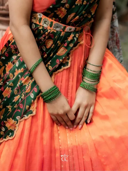 A mid-shot showing how the bottle green dupatta is draped and belted, creating a polished and elegant half saree look.
