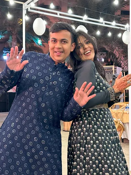 A guest at a destination wedding in Bahrain, wearing our deep navy blue kurta with intricate mirror work embroidery. An exquisite choice for an enchanting Sufi night.