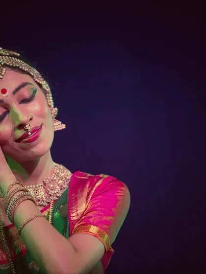 A moment of peace and contentment, with eyes closed and a gentle smile. The lighting creates a soft, dreamlike mood.