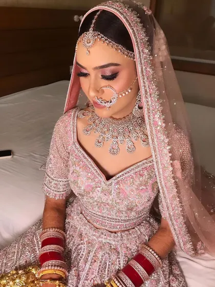 A bride in pink is always a beautiful sight. I created a soft, romantic look with pink shimmery eyes for her pastel lehenga.