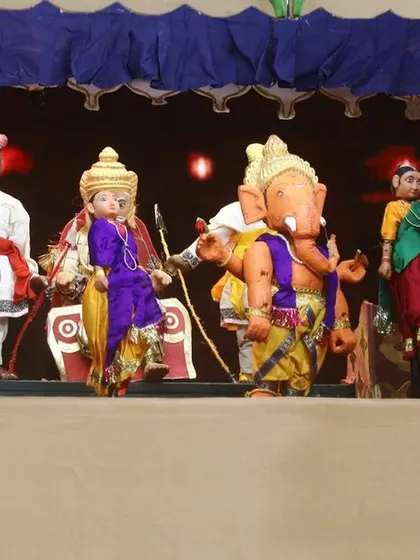 A close-up of the traditional string puppet stage, featuring characters like Lord Ganesha. This segment honors the cultural roots of Indian puppetry.