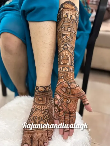 A complete bridal look with a full-arm design on one hand and a matching foot design. Both feature peacocks and traditional patterns.