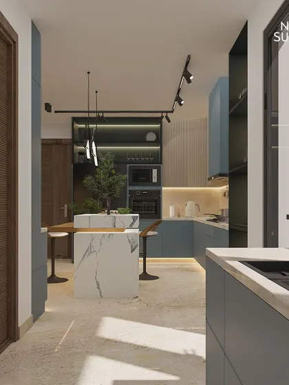 Another perspective of the Ireo Hills kitchen, highlighting the seamless integration of state-of-the-art appliances and strategic track lighting. This view shows the galley layout and the connection to the pantry.
