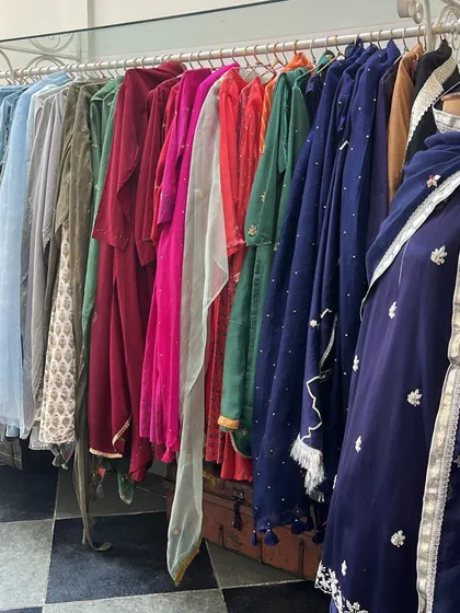 A rack of rich velvet and embroidered outfits in a Jaipur boutique. The city is a fantastic destination for sourcing unique and luxurious festive wear.