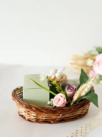 A simple and elegant baby announcement gift. This small wicker basket is filled with a few of our favorite treats and decorated with florals.