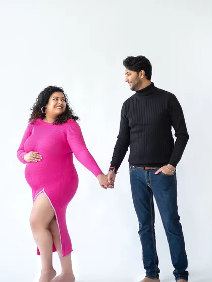 A walking pose in the studio, creating a sense of movement and narrative. The couple looks relaxed and happy as they walk toward their future.
