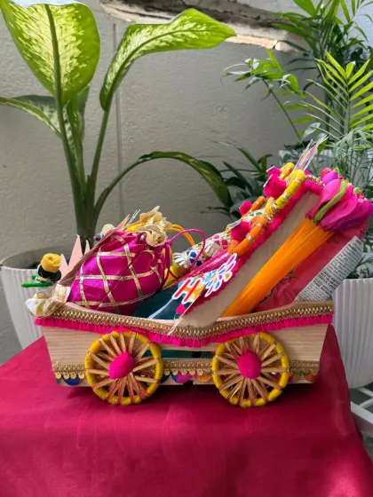 A side view of the premium Holi cart hamper. The detailed decoration and abundant contents make it a truly impressive and generous gift.