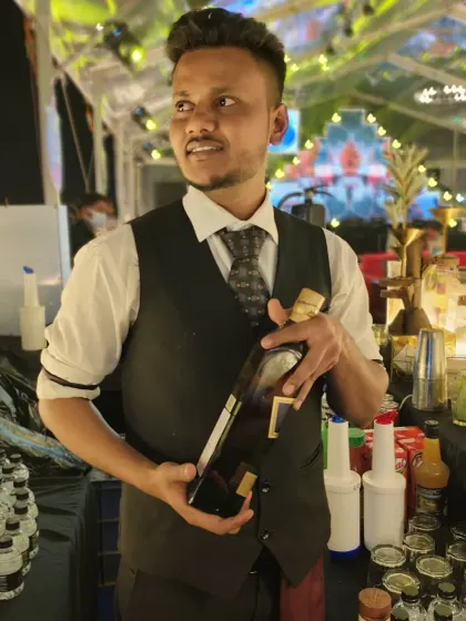 Posing with a premium bottle at a wedding event. I can source and serve a wide range of high-end spirits to create a top-shelf bar experience for your guests.