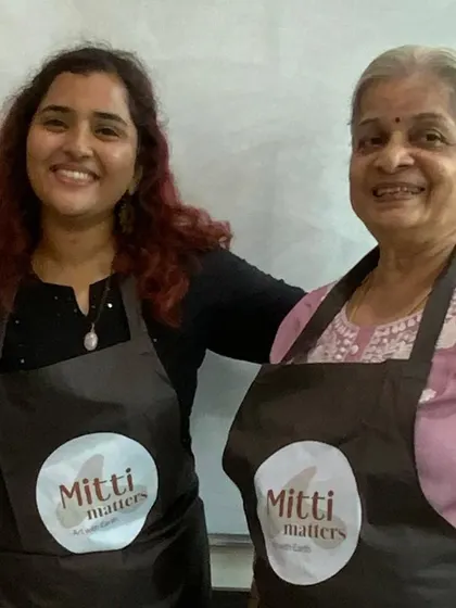 Posing with Vimala ma'am, wearing our Mitti Matters aprons. These workshops are built on the support of a strong, empowering community.