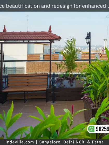 A traditional wooden swing with a tiled roof, integrated into a terrace design. Surrounded by lush plants, it offers a perfect spot for relaxation with a view of the city.