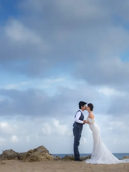 A kiss against the horizon, where the sky meets the sea. This is a classic, romantic pose that we capture during a destination pre-wedding shoot in Bali.