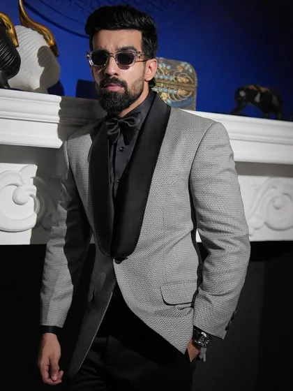 The details make the difference. Here, the shawl lapel and coordinated bow tie complete this distinctive formal look, showcasing a modern approach to classic evening wear.
