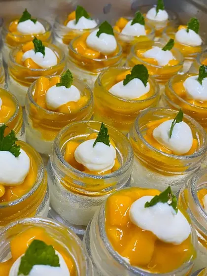 The colors of summer in a jar. Our Mango Mousse Jars are layered with creamy mousse and fresh mango chunks, a tropical delight.