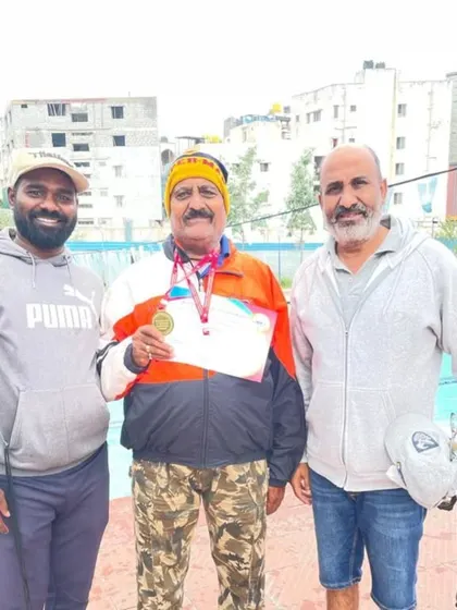One of our senior champions with his coaches after a successful meet. This photo captures the pride and camaraderie that defines our training center.