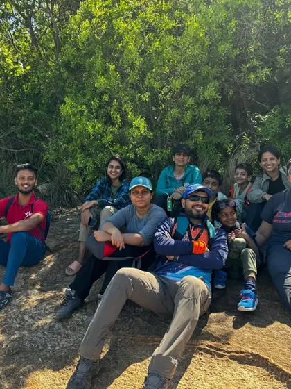 A relaxed group of trekkers taking a break on the rocks.