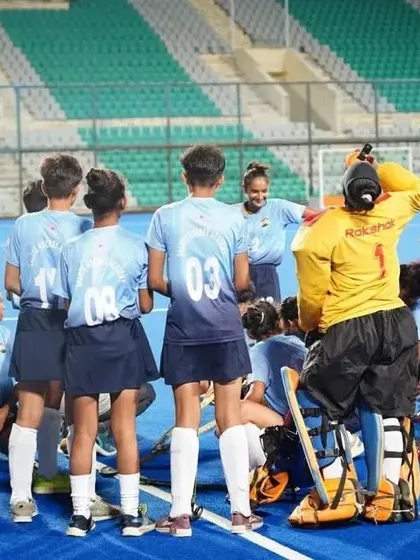 A quick strategy session with the coach during a break in play. I believe in hands on coaching, providing constant guidance and motivation to my players right on the field.