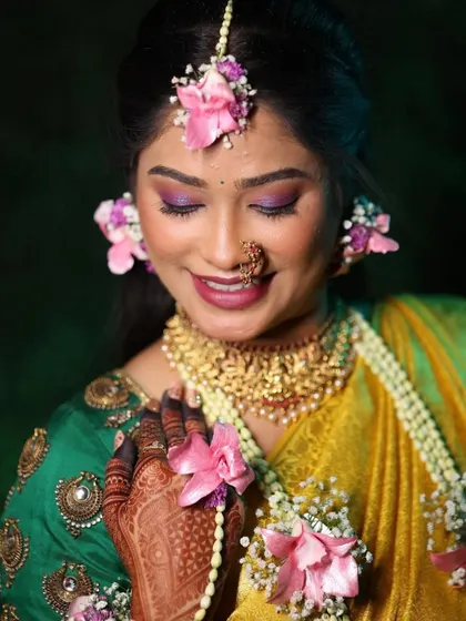 A close-up of a vibrant Haldi look. I love using fresh floral jewelry to complement the bright, joyful makeup, creating a look that is both traditional and wonderfully fresh for the ceremony.