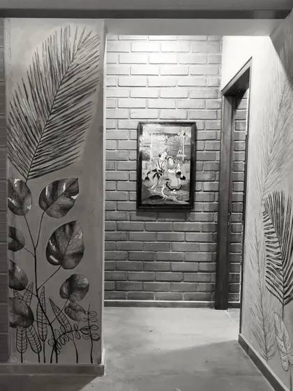 A house becomes a home as art and personal touches are added. Here, custom wall art complements the texture of the exposed brick wall.
