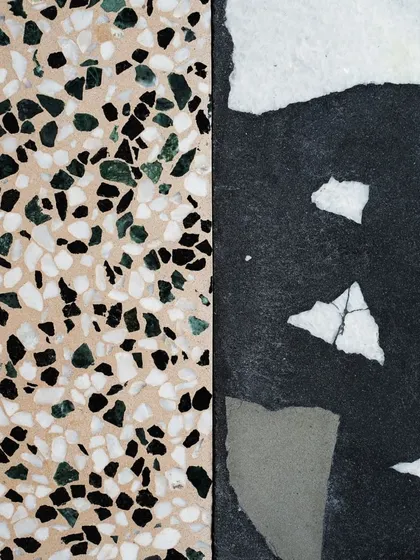 A side-by-side comparison of two new designs: a beige terrazzo with green and black chips, and a dark Venetian terrazzo with large white and grey chips.
