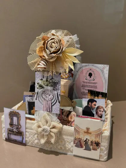 We bring your favorite themes to life, like this elegant Bridgerton-inspired hamper. It's filled with curated items that capture the regency era vibe, all arranged in a beautiful lace-covered basket.